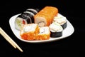 Appetizing Japanese sushi rolls on a dark background