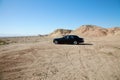 Rolls Royce car parked on unpaved road with tire tracks