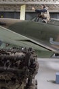 Rolls Royce Merlin engine broken in foreground with blurred Hawker Hurricane in background. Royalty Free Stock Photo