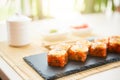 Rolls with shrimp in a black plate on a wooden table. Sushi closeup Royalty Free Stock Photo