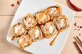 Rolls with shrimps, cream cheese, tomatoes and Spicy sauce in white plate top view Royalty Free Stock Photo