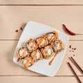 Rolls with shrimps, cream cheese, tomatoes and Spicy sauce in white plate top view Royalty Free Stock Photo