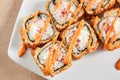 Rolls with shrimps, cream cheese, tomatoes and Spicy sauce in white plate top view Royalty Free Stock Photo