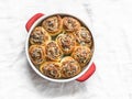 Rolls stuffed with herbs and soft cream cheese on a light background, top view. Snack, appetizer buns
