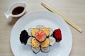 Rolls and sushi folded in the form of a cake on a white plate Royalty Free Stock Photo