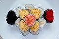 Rolls and sushi folded in the form of a cake on a white plate Royalty Free Stock Photo