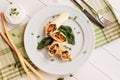 Rolls of thin pancakes with smoked salmon, horseradish cream cheese and spinach leaves. Side view with copy space Royalty Free Stock Photo
