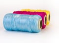 Rolls of thread with CMYK colors.