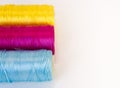 Rolls of thread with CMYK colors.