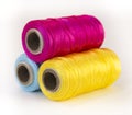 Rolls of thread with CMYK colors.