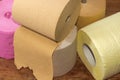 Rolls of toilet paper different quality and colors fragment closeup