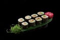 Rolls unagi maki on bamboo leaf on black background Royalty Free Stock Photo