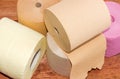 Rolls of various toilet paper different colors closeup