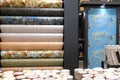 Rolls of vinyl wallpaper in a building supermarket, store, market. Dense wallpapers of different colors and patterns for