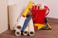 Rolls of wallpapers and various tools for wallpapering.