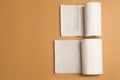 Rolls of white paper towels on brown background, flat lay. Space for text Royalty Free Stock Photo