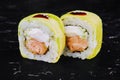 Rolls wrapped in avocado with fried salmon inside Royalty Free Stock Photo