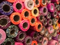 Rolls of wrapping paper in red, purple, green, burgundy, orange and pink