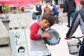 Roma boy singing and playing darbuka asking for money downtown of Skopje, capital of Macedonia Royalty Free Stock Photo