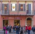 Roma football club shop door with ground floor and first floor with pink painted wall in Rome city center.