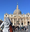 A nun looking at the Basilica at St. PeterÃ¢â¬â¢s Square with the egyptian Obelisk. Vatican City, Rome, Italy. Royalty Free Stock Photo