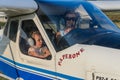 ROMA, ITALY - AUGUST 2018: Female instructor and little girl child at the helm of a light aircraft Tecnam P92-S Echo