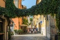 ROMA, ITALY - AUGUST 2018: Tourists walk through the narrow ancient streets of Rome