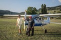 ROMA, ITALY - AUGUST 2018: Two pilots are standing near their light-engine aircraft Tecnam Echo