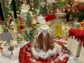 ROMA, ITALY - DECEMBER 6, 2022: Delicious Pandoro cake on decorated table at the interior of garden shop