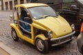 Roma, Italy - January 04, 2012: Yellow mini car Ligier Be Two, ATV, city subcompact with diesel engine, automatic transmission. Royalty Free Stock Photo