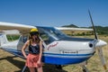 ROMA, ITALY - JULY 2017: Beautiful young girl pilot near a light aircraft Tecnam P92-S Echo