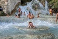 ROMA, ITALY - JULY 2019: Young charming girl bathes in the healing thermal mineral springs in the resort of Saturnia Italy