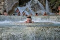 ROMA, ITALY - JULY 2019: Young charming girl bathes in the healing thermal mineral springs in the resort of Saturnia Italy