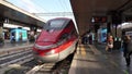 Roma, Italy. Termini train station. Many people are walking to the departure of the train. High speed train Freccia Rossa 1000