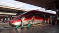 Roma, Italy. Termini train station. Many people are walking to the departure of the train. High speed train Freccia Rossa 1000