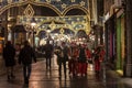 Roma music band playing in the streets of belgrade at night with christmas decoration dressed as santa claus.