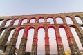 Roman aqueduct of Segovia at sunset, with detail of Virgin of the Aqueduct, located in the central niche of the monument has since