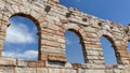 Roman arches in Verona against blue skies