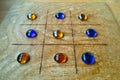 Replica of Roman board game Tic-Tac-Toe with playing stones