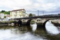 Roman bridge over the Ria de Betanzos with a strong current and Royalty Free Stock Photo