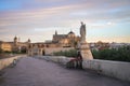 Roman Bridge at sunrise with San Rafael Statue and Cathedral of Cordoba - Cordoba, Andalusia, Spain