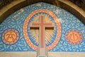 Roman Catholic cross over the entrance of a church Royalty Free Stock Photo