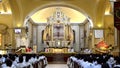 Roman Catholic priest saying homily at altar