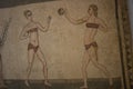 Roman girls in bikinis on mosaic floor