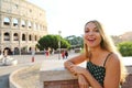 Roman Holiday. Smiling beautiful tourist girl in Rome, Italy. Attractive fashion woman with Colosseum on the background Royalty Free Stock Photo