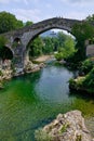 Roman hump-backed bridge on the Sella River in Cangas de Onis, Asturias, Spain Royalty Free Stock Photo