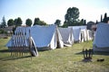 Roman legionary camp with tent, shields, helmets and army insignia