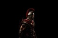 Roman legionary soldier in red armor and helmet over black background. Royalty Free Stock Photo