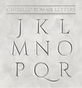 Roman letters chiseled in marble stone. Royalty Free Stock Photo