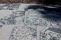 Roman mosaic with small black and white stones tiles representing a decoration. Detail of swirl depicted in a mosaic in Ostia Ant Royalty Free Stock Photo